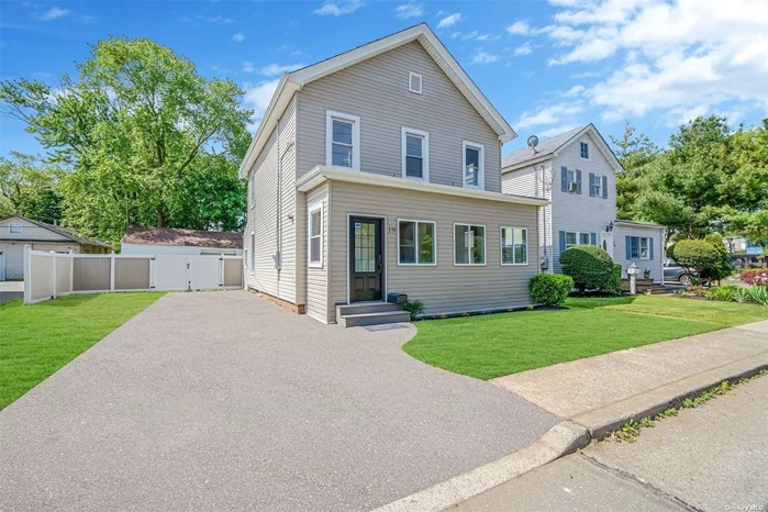 Charming 3 Bedroom 2 Bathroom Colonial With High Ceilings. This home is newly renovated with a New Bathroom and kitchen. Features an Enclosed Porch And a large Detached 4 Car Garage!!! All Located Right In The Heart Of Amityville Village Close To Restaurants Bars & LIRR