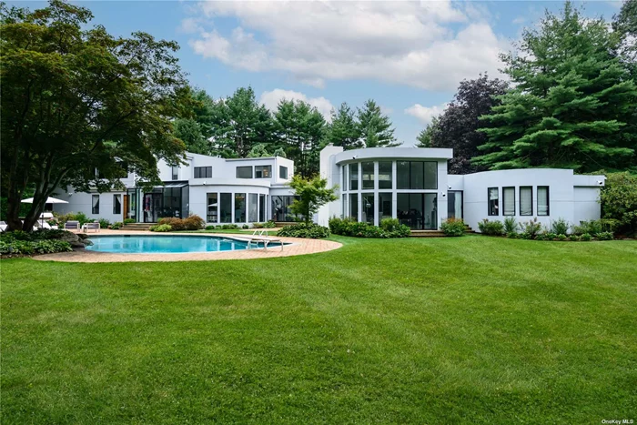 A spectacular, stunning, designer-owned Contemporary gated home nestled on sprawling, two flat acres on a quiet cul-de-sac in the sought after village of Old Westbury. This magnificent approximately 10, 000 sq ft home boasts seven generously sized bedrooms, each with its own en-suite bathroom. The house exudes modern elegance, with floor-to-ceiling windows, vaulted cathedral ceilings, with an abundance of natural light and panoramic views. The backyard oasis showcases a resort-style sparkling heated gunite pool, tennis/pickleball court, basketball court, playground, and an oversized patio with built-in outdoor kitchen, perfect for entertaining. On the main floor you enter through a dramatic foyer, looking over a spacious elegant dining area, luxurious living room, with beautiful fireplace and wet bar, a warm and inviting den, exquisite powder room, The heart of the home is a large gourmet kitchen with state-of-the-art appliances, plenty of counter space, and a breakfast area that invites the outside beauty in. The luxurious primary suite is a sanctuary of sophistication, offering a private retreat, with a spa-like en-suite bath and sauna, dressing area, sitting area, office and ample closet space. Step up to the upper level with a dramatic staircase to an additional 4 generously sized en-suite bedrooms and a recently added guest suite containing a bedroom, bathroom, kitchen, and living room, and balcony. The lower level is the perfect place for recreational activities, it&rsquo;s a sportsmen&rsquo;s paradise and includes an indoor racquet ball/wally ball/ basketball court, home gym, full bath, play area, art closet, ping pong, laundry room, bedroom, office and storage. Other amenities include a 2-car garage, maids&rsquo; room with full bath, central vac, security system, surround sound speaker system, mudroom and a sports court viewing area. Everything at your fingertips including easy access to the city and the Hamptons, low taxes. Near shopping, dining, golf/country clubs, and much more!