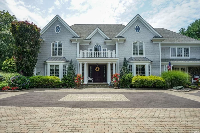 Welcome to an unparalleled living experience in the heart of the prestigious Oyster Bay Estates. This exquisite residence, the builder&rsquo;s and designer&rsquo;s own custom re-built in 2004, epitomizes luxury and sophistication. Set on two flat, pristine acres of lush, mature landscaping, this private oasis offers the finest in contemporary living within the renowned Syosset School District. Upon entering, you are greeted by a grand double-height ceiling foyer that sets the tone for the elegance found throughout the home. Extensive millwork and moldings are found throughout the home, enhancing the architectural beauty of each space. The interior of the home boasts solid wood floors, an expansive formal dining room, a refined formal living room, and a spacious great room featuring a coffered ceiling, a wood-burning fireplace, and a wet bar-perfect for both intimate gatherings and grand entertaining. The great room seamlessly flows into a stunning sunroom, offering a serene retreat bathed in natural light. The gourmet eat-in kitchen is a chef&rsquo;s dream, with radiant heated limestone floors, a substantial center island, an 8-burner Thermador cooktop, dual Dacor wall ovens with a warming drawer, and a Sub-Zero refrigerator. Adjacent to the kitchen is a cozy TV room, ideal for casual relaxation. The first floor also includes a powder room, a full bathroom conveniently located by the backdoor for pool access, and a side entrance mudroom with custom built-in cabinetry, ensuring both style and functionality. Ascending to the second floor, the primary suite is a sanctuary unto itself, featuring a generously sized bedroom, an expansive walk-in closet, and a lavish primary en-suite bathroom with radiant heated floors. The second floor also includes a full bathroom, an additional bedroom, and two more bedrooms, each with its own en-suite bathroom and full walk-in closets. An oversized versatile fifth room can serve as a bedroom, office, gym, or an additional living space, tailored to your needs. The fully finished basement extends the living space, offering an additional 6th bedroom, ample storage, a recreational room, and a temperature-controlled wine room for the connoisseur. Outdoors, the property is equally impressive. The backyard is an entertainer&rsquo;s paradise, complete with a heated pool with an electric cover, a patio area with a hot tub and fire pit, an expansive outdoor gazebo with a gas fireplace, and a fully equipped outdoor kitchen with all Viking appliances. A lighted tennis court and a tranquil koi pond further enhance the allure of this magnificent estate. The property is secured by a 20kW Generac generator and has an attached 3-car garage providing ample space for vehicles, further enhancing the convenience and luxury of the home. This home and property are in immaculate condition-truly a turnkey home. Experience unparalleled privacy and luxury in one of the most sought-after communities, where every detail has been meticulously curated to offer a lifestyle of absolute refinement.