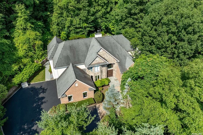 Prepare to be impressed! Two-story foyer greets you as you enter this stately brick/stucco Colonial with sprawling floor plan in the sought-after Village of Laurel Hollow/Cold Spring Harbor School District. Recently renovated, featuring 27&rsquo;x14&rsquo; eat-in kitchen with breakfast area featuring walls of windows, granite countertops, double wall oven, stainless steel appliances, and butler&rsquo;s pantry leading to formal dining room. Adjoining 17&rsquo;X24&rsquo; family room with fireplace and vaulted ceiling, plus formal living room with fireplace. Bedroom, 1.5 bathrooms, office/bedroom, and mudroom/laundry room off 3 car garage complete the first level. Second level encompasses 4 bedrooms, including an en-suite and primary bedroom with 2 walk-in closets, and marble bathroom. Finished basement with high ceilings provides additional recreation space, gym, office, and more. Privacy surrounds this resort-like backyard with estate fencing, heated saltwater pool, outdoor bult-in BBQ with beverage fridge and bar seating. Situated on just over 2 acres, only minutes to Oyster Bay and Cold Spring Harbor Villages, train station, schools, parks, and Laurel Hollow Village private beach with kayak storage and mooring rights (fee). Total Taxes: $36, 338/yr