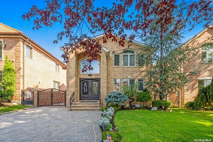 Welcome to this thoughtfully designed home in the North Flushing / Whitestone border. As you approach, the brick paved driveway entrance with room for two cars leads you to the two-story entrance with a custom wrought iron door. The entry foyer welcomes you with views of both the second story staircase to the left and the beautifully proportioned living and dining areas on the right. Walk past the living room to view the eat-in kitchen with stainless steel appliances including a built-in refrigerator. Move your eyes to the rear of the home through pocket doors to a light filled primary bedroom (currently being used as a second living room) with access to the backyard. A full bathroom completes the first floor.  Head to the second floor to access the second primary bedroom with double walk-in closets, two additional bedrooms with built in desks and a full bathroom. The basement offers an additional 1, 106 sf of living space including a summer kitchen with walk-in pantry, laundry room, full bathroom and an open space used as a media room / home office. Additional features: French drain to keep the home dry, ductless A/C unit in the basement and central A/C for the first and second floors.