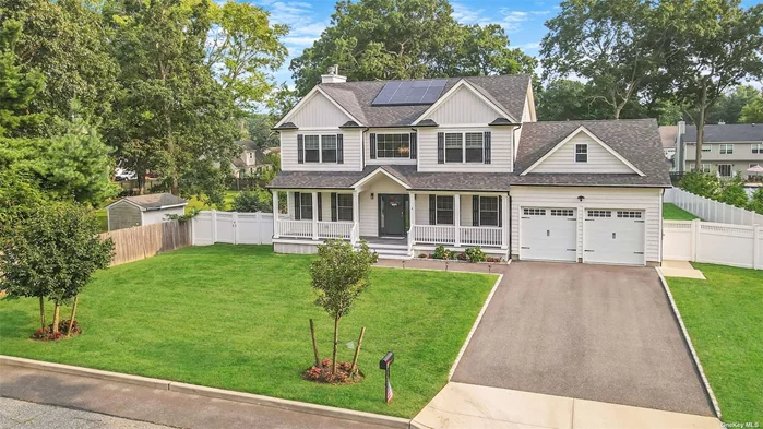 Welcome to this magnificent 3-year-old custom Colonial home in Lake Grove, where luxury and modern convenience meet in perfect harmony. This grand residence features an expansive open floor plan, epitomizing sophistication and style. At the heart of the home is a stunning eat-in kitchen, showcasing custom Fabuwood grey cabinets, a 36 stove top, a 36 farm sink, a double oven, a wine fridge, and sleek quartz countertops. The distinctive custom backsplash adds a unique touch to this culinary space. The home boasts four generously sized bedrooms, each designed with high ceilings and exceptional craftsmanship. The primary bedroom is a true retreat, offering a luxurious master bath with custom tile and a state-of-the-art lighted mirror that provides defogging capabilities and weather updates. The three secondary bedrooms are spacious, each with ample closet space, while the shared bath features custom accent tile for added elegance. Custom features throughout the home include striking lighting, retractable fandeliers, and shiplap feature walls. The motorized light lift chandelier adds a touch of grandeur, while the generous pantry, laundry room with slop sink, and mudroom enhance both luxury and practicality. Elegant hardwood floors extend throughout, complemented by a grand wood-burning fireplace in the den, crown molding, and wainscoting. The unfinished basement includes an egress window and an outside entrance, offering potential for future expansion. Solar panels have been installed to significantly reduce the electric bill. The property is enclosed with PVC fencing and features a Trex front porch. At the back, Trex steps lead to a spacious concrete patio and a flat, green yard-perfect for outdoor entertaining. Additional highlights include gutter guards and an oversized 2-car garage. This home offers an exquisite blend of luxury, space, and practicality in a serene Lake Grove setting.