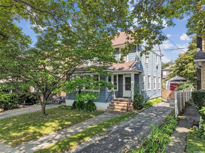 Charming Colonial with Private Yard and Convenient Location Discover a wonderful opportunity to own a spacious and classic colonial home, ideally located near the LIRR and Bell Blvd, with easy access to excellent restaurants and shops. This lovely residence features: Hardwood Floors throughout the home, adding warmth and character. Banquet-Size Dining Room, perfect for entertaining and hosting gatherings. Enclosed Porch, versatile as a cozy den or a productive home office. Walk-Up Attic, offering extra storage space or potential for customization. Full Basement with laundry facilities and ample room for additional storage. Enjoy the privacy of a serene yard and the convenience of a private driveway, all in a central and desirable location.