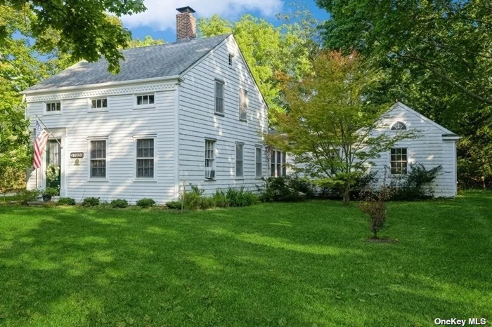 Beautifully restored and updated Colonial Path House. The front facade of the house has been restored to clapboard siding and cedar shake. The original rooms on the first floor include a cozy parlor with wood burning fireplace, an adjacent dining room, farm kitchen and full bath/laundry room. All with antique wide plank floors. The second floor has 2 bedrooms and large storage closet, as well as a full bath with an antique soaker tub. A new addition doubled the living area. The design of the addition compliments the old part of the house while modernizing the space with an ensuite bedroom, living room, a year-round sunroom, wide plank hardwood floors and working fireplace with a hand carved mantle from a Victorian Mansion. The kitchen has been updated with built in cabinets, a farm sink, a Bosch dishwasher and Viking stove. A bluestone patio is directly off the Primary bedroom. A successful and popular bed and breakfast was operated in this new addition. An accessory cottage is perfect for your studio or office. House in the heart of wine country. Top Southold Restaurants: John Fraser&rsquo;s North Fork Table  and Chef Panyard&rsquo;s Southold Social. Note: Access to Founders Landing Beach.