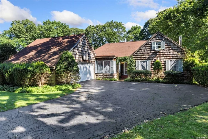 Set amongst the trees and sitting along the coast of the Long Island Sound, this darling 3-bedroom country-style farm ranch has all the pleasure of single level living combined with a 2-car garage with overhead storage, large asphalt driveway, central air, and wood burning fireplace. Outfitted with double hung Anderson windows, new Biasi boiler, hardwood doors, 200 Amp electrical service with generator hook up, and a large unfinished basement with dedicated chimney for an additional fireplace. This ground level basement is ready to be made into a supreme recreation room or apartment with 2 sliding glass doors that exit out to the backyard and a red brick patio. The .40 acre lot creates sunken privacy, and a flat grassy area set beneath the wrap-around lumber deck with dual staircases. Settle into the den with its post & beam ceiling detail at the rear beside the fireplace or plan an evening with company to take advantage of the formal dining room with vinyl plank flooring overlooking the backyard. The primary bedroom offers a walk-in closet, and a full standup attic gives that extra storage we all need. The separate laundry room sits opposite the step-in pantry just feet away from the spacious eat-in kitchen with hardwood cabinetry.