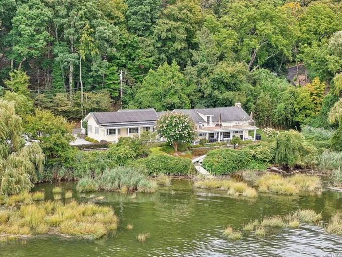 Nestled along the tranquil Nissequogue River, this exquisite waterfront residence offers an unparalleled sanctuary for the discerning buyer. Set on 4.08 sprawling acres with 979.32&rsquo; of waterfrontage in the private Village of Nissequogue, this meticulously renovated four-bedroom, two-and-a-half-bath home seamlessly blends the charm of yesteryear with modern amenities and sophistication. The property&rsquo;s allure begins with its stunning exterior, where gorgeous waterviews and beautiful plantings create a nature lover&rsquo;s paradise. A bluestone covered southern style back porch and private dock provide idyllic spaces for outdoor entertainment, allowing residents to bask in the glory of breathtaking sunsets over the river. Upon entering, one is immediately struck by the home&rsquo;s high-end custom details and quality craftsmanship throughout. The formal living room features soaring ceilings and walls of glass that provide stunning waterviews. A spacious dining room and charming kitchen, complete with white cabinetry, farmhouse sink, ample counter space, breakfast bar, and Viking gas stove, cater to both quiet dinners and intimate gatherings at home. The primary suite is a true retreat, boasting vaulted ceilings, a walk-in closet, large picture windows with river views and a luxurious bathroom featuring a custom vanity, shower, and tub. Three additional bedrooms and updated bathrooms ensure comfort for everyone. Throughout the home, thoughtful touches abound - from the original stone fireplace in the family room to the old world curved stairway and dual staircases. A wonderful large roof top Trex deck offers another gorgeous space to relax and unwind while enjoying the breathtaking water views. Modern conveniences include: updated gas heating system, 200 amp electric, heat pumps, central air, solar panels, updated roof, updated windows, inground sprinklers, updated appliances, ample closet space, and a full house Generac generator. This one-of-a-kind property, brimming with character, warmth, and charm, offers a rare opportunity to own a piece of riverfront paradise. It&rsquo;s more than just a home; it&rsquo;s a lifestyle embracing nature, tranquility, and timeless elegance.