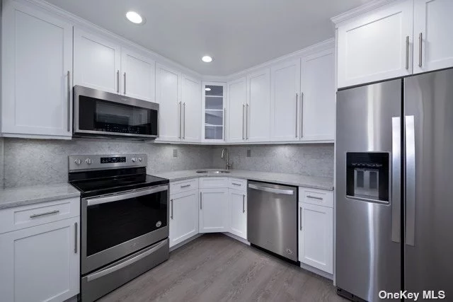 Lovely courtyards.Tudor architecture.Tennis.Path to Belmont State Park.Shaker-style kit/bth cabinets.Quartz ctrtop/backsplash/plank tile flr/gray carpet.Gray paint. Frmls shwr drs.subway tile bth/quartz vanity/basketweave flr tile.Hi-hats.Ceil fans.Whirlpool gold stls.stl.appl.Terrace.Nr LIRR So.St.Pkwy.Rte231/DeerPark Ave.LIE495. Prices/policies may change w/o notice