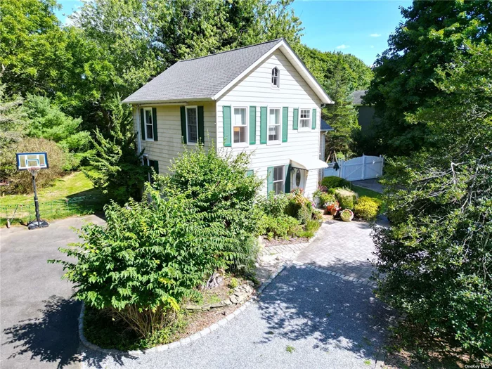 This enchanting historical home in Remsenburg sits on a picturesque .83-acre lot, offering 3 bedrooms and 1 and 1/2 bathrooms. Rich with character, the residence features original architectural details, including hardwood floors, and exposed beams. The spacious yard, surrounded by mature trees, provides a peaceful retreat in a highly sought-after neighborhood.