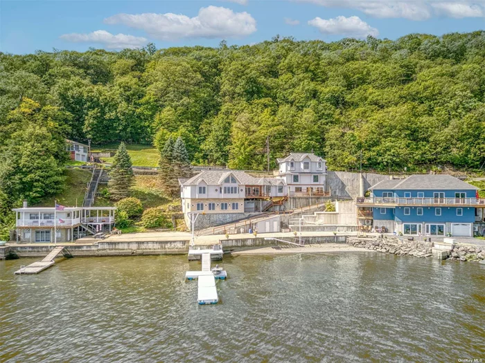 100ft of Waterfront on the Hudson River with Beach Access                                                                                                                                          Nestled on an exclusive waterfront road, 105 River Road offers a rare opportunity with 100 feet of private docking and a one of a kind beach. This one-of-a-kind property, built by the original owner, sits 30 feet above the Hudson River, providing endless possibilities for its next owner.                                                                                                                                                                The main house features an upper-level 2-bedroom, 2-bathroom layout, complete with a 3-season entertaining gazebo and a spacious covered terrace.                                                                                                                                                                          The lower level, which can be locked off from the upstairs for privacy, includes a separate 1-bedroom, 1-bathroom unit with its own kitchen and private entrance-perfect for rental income or guests. Every room in the main house boasts stunning water views and is bathed in natural light.                                                                                                                                                                                      A triplex outbuilding, connected to the main house by an enclosed catwalk, offers additional potential. Currently, it includes an upper-level single-car garage, an elevator, and two lower levels that can be customized to suit your needs-whether as guest rooms or creative spaces.                                                                                                                                                                    Outside, the property showcases a remarkable 3, 500-square-foot private concrete dock/pier with a parking lot (lower parking is exclusive to 105 River Road), a half bathroom, running water, electricity, and a power crane for supporting floating docks and small boats. Lower neighboring house does not have parking or drive way rights and a fence can be constructed for additional privacy.                                                                                                                                                                                 The floating dock extends 78 feet from the pier and is permitted for a 100-foot permanent pier. A private stone beach, accessible via a high-density steel power bridge, is perfect for fishing enthusiasts, offering access to some of the best Striped Bass fishing on the Hudson River. Conveniently located just a ten-minute drive from the Roundout waterfront with its excellent dining and shopping, 20 minutes from train and bus services for easy commutes to NYC, and two hours by car to the GW Bridge.                                                                                              Local Attractions: -Maynard Farms -El Paso Winery -High Banks Preserve -Lighthouse & Historical Marker -Hudson River Cruise Boat (10 minutes from the house) -George Freer Memorial Park / Beach (5-minute drive) -Sleightsburgh Park (7-minute drive) -Train Station (22 minutes / 14 miles) -Rhinecliff Amtrak Station to New York Penn Station (1 hour 51 minutes)