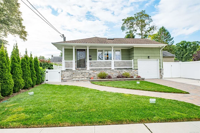 Nestled in a peaceful cul-de-sac, this home offers a tranquil setting with convenient access to the parkway and LIRR. This charming 3-bedroom home features a lifetime roof installed 7 years ago, a new 2-stage boiler, gas hot water heater, and an oversized 2.5-ton central AC system for efficient climate control. The front of the house features an updated look with a new porch, pavers and concrete, creating an inviting and modern entrance. Step inside to discover brand new floors throughout. The first floor showcases an open-concept living and dining area, highlighted by a spacious deck just off the dining room-perfect for outdoor meals and relaxation. The eat-in kitchen is equipped with a gas stove, while the master bedroom suite includes a convenient half bath. The basement has been thoughtfully renovated with a large family room, a split AC and heating system, ensuring comfort and functionality. Outside, the large, fenced-in yard features a pet-proof setup with astroturf, pavers, and concrete, making it ideal for gatherings and play. This home combines modern amenities with a welcoming atmosphere, offering a perfect blend of comfort and convenience.