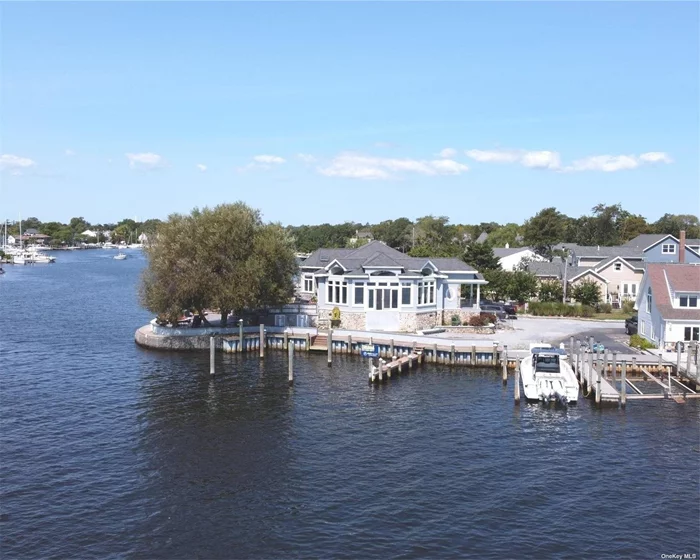 This stunning custom-built luxury home is nestled on a charming, tree-lined street in a highly sought-after community, offering serene views of the Great South Bay. Imagine enjoying a short boat ride to Fire Island right from your own backyard, complete with four private boat slips. Plus, you&rsquo;re just moments away from vibrant downtown Babylon. As you approach, the blend of gravel and stone pathways, along with the unique location of the home on Sumpwams Creek-a natural and deep waterway with unobstructed 180-degree views-makes it feel like you&rsquo;re on your very own island. Step inside, and you&rsquo;ll be greeted by marble floors with radiant heat and exquisite 14&rsquo; high ceilings with European contemporary designs. The bright, open floor plan seamlessly connects the kitchen, living, and dining areas, leading you to a sun-soaked, resort-like backyard. This stunning retreat was custom-built by an Olde European World craftsman, showcasing meticulous attention to detail throughout. The kitchen boasts granite countertops, a customized backsplash, elegant cabinetry, high-end appliances, and beautifully finished molding, all enhanced by radiant heating throughout the home. Throughout the home, the refined use of mahogany wood, iron, etched glass, stone, and marble creates a true trophy property. The breathtaking, postcard-perfect views of the Great South Bay fill the home with natural light and provide amazing sunsets-truly a water lover&rsquo;s oasis. Just 500 feet from your boat to the bay, this property invites you to experience waterfront living at its finest.