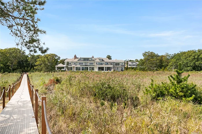 Just finished new construction south of the highway in the prestigious Village of Quogue. This 3-acre estate offers unparalleled waterfront living with direct access to Shinnecock Bay via a private boardwalk. The property boasts a maintenance-free exterior with stylish house shingles and an expansive outdoor living area, featuring a full outdoor kitchen, BBQ, pizza oven, and bar. Enjoy the oversized hot tub, heated saltwater infinity-edge pool, and beautifully landscaped grounds. Step inside to a grand foyer showcasing a custom mahogany wine room. The primary wing is a sanctuary with a bedroom featuring a fireplace, wet bar, and private balcony. The luxurious en-suite bathroom includes a steam shower, tub, and a second balcony. The suite also offers his-and-her walk-in closets and a dedicated office. The home accommodates guests with six bedrooms, each with an en-suite bathroom and walk-in closet. Additional highlights include two bonus rooms with wet bars and balconies, first and second-floor laundry rooms, two extra powder rooms, a spacious great room with fireplace, sauna and even your own personal movie theater. You will also enjoy an outdoor pergola with a full bar and wood-burning fireplace.  The kitchen is a chef&rsquo;s dream, featuring double islands, top-of-the-line appliances, a butler&rsquo;s pantry, and panoramic doors opening to the bay. A motorized kitchen window provides access to the screened-in porch, which includes motorized screens and built-in heaters. Interior highlights include stunning water views from every room, extensive millwork, ceiling treatments, a Lutron lighting control system, custom oak flooring, vaulted ceilings, and A-Series windows. Don&rsquo;t miss this exceptional opportunity to own a fully custom Summerhouse Builders waterfront home in Quogue.