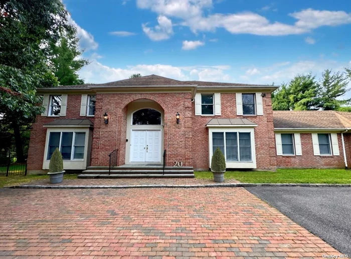 Welcome to 20 Carlisle Drive in Old Brookville, a wonderful North Shore center hall colonial nestled on a serene, tree-lined private cul-de-sac. Offered for the first time since its construction, this residence features 5 bedrooms, 4.5 bathrooms, and is situated on two acres, complete with a gunite pool and tennis court. As you enter the home, you are greeted by a grand two-story foyer. Continuing down the main hallway, you will find a charming formal dining room with bay windows, a spacious living room that opens to a cozy den with fireplace - perfect for gatherings - and a convenient powder room. The large eat-in kitchen is the heart of the home. It features room for a sizable table, a breakfast bar, an island with built-in range top, double wall ovens, a Sub-Zero refrigerator, and ample cabinet and counter space. Beyond the kitchen, there&rsquo;s a laundry area, a full bathroom, and a versatile first floor bedroom which can serve as a guest suite or office. Adjacent is a large great room with a fireplace, recessed ceilings, and access to the two car garage. Upstairs, the primary suite features two walk-in closets, a cedar closet, and a bright, skylit en-suite bathroom with large shower, spa tub with views of the pool area, bidet, and double vanity. Down the hall from the primary bedroom are three additional spacious bedrooms, each with oversized closets, and a shared full bathroom with double vanity. Outside, the sprawling brick patio, gunite pool, elevated tennis court, and additional open field space create a truly luxurious getaway. Whether you are looking to relax, play, or entertain, this property offers it all. Don&rsquo;t miss out on this fantastic opportunity to own in Old Brookville.