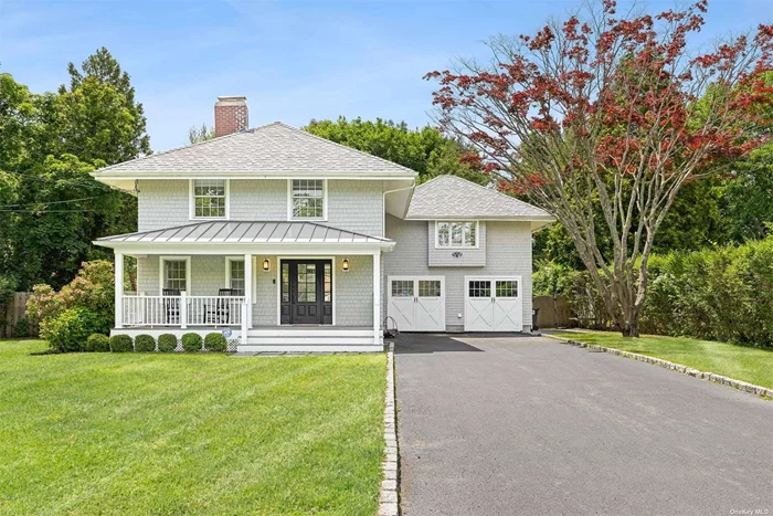 Renovated 1920s Farmhouse in the Village - This beautifully renovated classic 1920s farmhouse blends old world charm with modern-day living in the heart of Westhampton Beach Village. The grey cedar shake exterior, charming front porch with standing seam roof and mahogany decking welcomes you into the cozy front living room with wood burning fireplace and staircase to the second level. Just beyond the front living room is the coveted open floor plan with a custom renovated kitchen featuring top-of-the-line appliances and a center island open to the dining room and large den with wall-to-wall sliders leading to the large back deck facing the heated pool. The ideal design for indoor/outdoor living! There is also a mud/laundry room and full bathroom with an exterior door to the backyard completing the first level. The beautifully refinished original hardwood floors run throughout the first and second level. The second level comprises of a Master En Suite, four additional bedrooms and two beautifully renovated bathrooms. The attached garage has a Universal EV Charger. Some additional features include Ring System, 3 Zone Nest System, Irrigation, Alarm and CAC. Just two blocks from great restaurants and shops on Main Street. And 1.4 miles to Rogers Beach. It&rsquo;s quintessentially Hamptons!