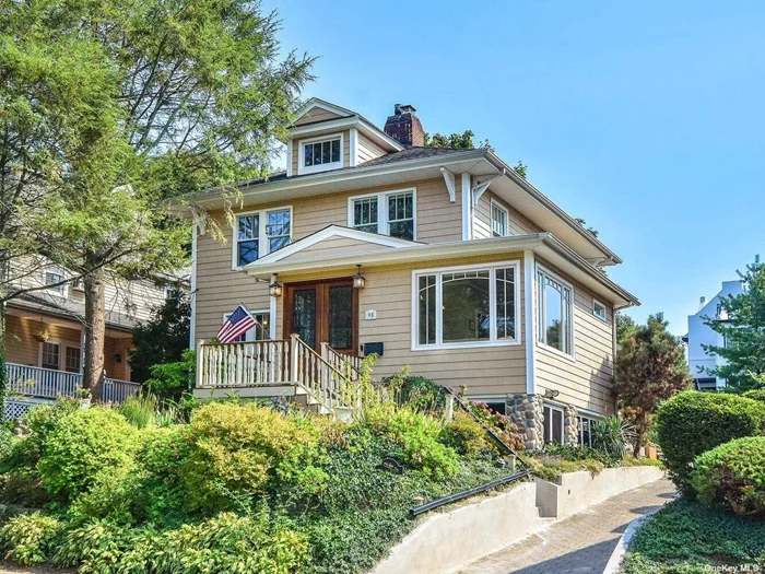 This handsome Colonial, Craftsman-Style home, centered in the heart of Port Washington, offers 4/5 bedrooms and an array of natural materials such as wood and stone; exudes all the warmth you want in a home. The first floor boasts high ceilings with exposed wood beams, a living room with a stunning stone fireplace as the focal point, and detailed custom mouldings which continue into the formal dining room and throughout the house. The first floor rounds out with a renovated kitchen, a versatile family room/5th bedroom en-suite modern full bathroom. Entertain year-round on the Pergola, accessible from the dining room and kitchen. The second floor has 4 bedrooms, a full bath and bonus third floor walk-up attic. Sunlight abounds with the over-sized windows found on both levels of living. The finished basement features a recreation room and office, and laundry area, half bath and storage. Additional amenities include radiant heat in the kitchen, 1st floor bathroom and family room/bedroom, CAC, Gas Heat, 2 car garage, mature landscaping, A tremendous plus-close proximity to the train, shopping, restaurants, parks, library, and beach with mooring (with fee & availability). Located in Port Washington Heights.