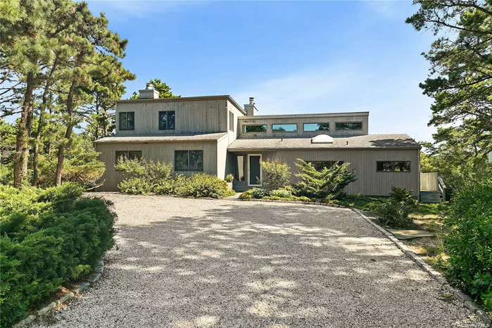 Enjoy sweeping views of a pristine Dune Preserve from this contemporary 2, 500 sq ft beach house in the coveted Amagansett Dunes. Located on a spacious .70-acre lot, this 4-bedroom, 3-bath home offers a perfect blend of comfort and privacy. The open kitchen flows into a stunning two-story living room, complete with a fireplace and a wall of sliding glass doors that open to a large wrap-around deck-ideal for entertaining. The first floor has three well-appointed bedrooms and two full baths, while the second floor is dedicated to a spacious ensuite master bedroom retreat. With private beach access just a few houses away and the tranquil dune preserve behind, this home offers the ultimate beach lifestyle in a serene and private setting.