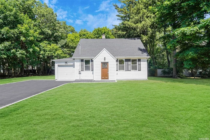 Completely Renovated in June 2024, this charming Cape Cod-style home in St. James features 3 bedrooms, 2 bathrooms, a partial basement, and a one car garage. Situated on over a half acre of land on a corner lot, it offers an open living space, a brand new modern kitchen with brand new stainless steel appliances and hardwood floors throughout. Prime location near schools, parks and shopping. Wooded lot to the left is part of the property.