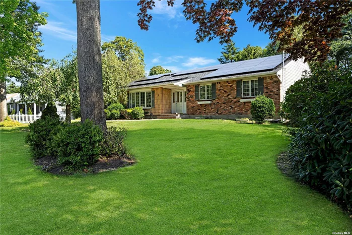 This expansive ranch-style home in Port Jefferson Station boasts three bedrooms and two baths. The property showcases elegant wood flooring, a recently updated kitchen with breakfast nook, stainless steel appliances, modern white cabinets adorned with accent molding, and granite countertops. Among its features are a formal living room, a formal dining room, and a spacious den complete with fireplace and access to the picturesque backyard. The master suite includes a renovated bathroom and walk-in closet, while two additional bedrooms share beautifully updated hall bath with soaker tub. Recessed lighting illuminates the main living areas. The property is equipped with a new energy-efficient boiler, a wood-burning fireplace with a stove insert, and owned solar panels that contribute to reduced energy costs. The solar financing is transferable with a low rate. Partial basement with laundry and utilities. Outside, you can relax in your private yard featuring a Trex deck, an in-ground pool with a new liner and updated systems. This home is complete with one car attached garage. Close to shopping, highways, schools, beaches, Port Jefferson Village, restaurants and more!