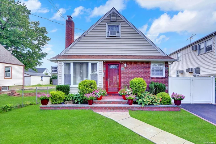 Welcome home to this charming expanded cape located in the heart of Elmont! Situated mid-block on a quiet, residential street with fantastic curb appeal, this inviting home features a spacious living room complete with a cozy wood-burning fireplace, perfect for gatherings. Beautiful hardwood floors run throughout the main living areas, adding warmth and character. The kitchen boasts wood cabinetry, sleek stainless steel appliances, and convenient gas cooking, making it ideal for any chef. The partially finished basement and additional rear family room provide ample spaces for recreation and storage. Conveniently located near local dining, shopping, schools, and all forms of public transportation. A must-see home in a desirable neighborhood!