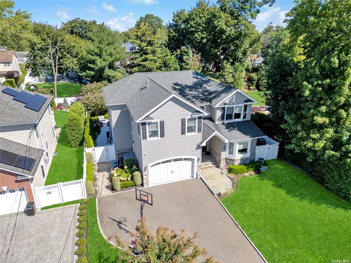 Welcome home to 3429 Silverton. This stunning Center Hall Colonial is located in the very desirable neighborhood of Wantagh Woods. This home is a mix of classic elegance and modern luxury. The home was built in 2015 and no expense was spared while designing this masterpiece.  Nestled in a serene neighborhood, this beautiful 4-bedroom, 3-bathroom home boasts timeless charm and exceptional craftsmanship. Step through the grand entrance into a spacious center hall foyer, where gleaming hardwood floors and sophisticated molding set the tone for the entire home. The expansive living room features a cozy fireplace and large windows that flood the space with natural light. Adjacent, the formal dining room boasts a tray ceiling with LED lighting and offers an ideal setting for holiday gatherings and special occasions.  The heart of the home is undoubtedly the chef&rsquo;s kitchen. Designed for both culinary excellence and entertaining, this kitchen is a true masterpiece. It features top-of-the-line appliances including a WOLF Dual Oven Stove with 6 burners, Bosch dishwasher, Miele Coffee system, custom cabinetry, and a generous hand crafted custom island with ample seating for everyone. The open floor plan seamlessly connects the kitchen and dining room to the large family room, which is perfect for relaxing or hosting guests. Pour a glass of wine or read a book while you cozy up to the gas fireplace. Step outside to your private outdoor retreat, complete with a beautifully landscaped yard, inground pool, Jacuzzi, and outdoor kitchen/bar-perfect for alfresco dining and enjoying warm summer evenings. The patio was built with Marmiro stone to ensure comfort and style while enjoying your backyard oasis. The serene environment offers a peaceful escape right in your own backyard. The second floor is dedicated to restful retreats, including a luxurious primary suite with a spa-like bathroom, double sink vanity, make up vanity and walk-in closet, as well as three additional well-appointed bedrooms that share a full bath. Each room has custom built in closets and have been designed with comfort and style in mind. You also have a washer and dryer on the second floor making laundry a breeze. The full basement adds even more value to this exceptional home. It features a versatile space perfect for a home gym, play area, or hangout are for the kids. Additional features include a one and a half-car garage with charging station, extra storage space and central air conditioning for year-round comfort. Don&rsquo;t miss your chance to own this exquisite Center Hall Colonial that combines timeless charm with modern amenities in beautiful Wantagh Woods.