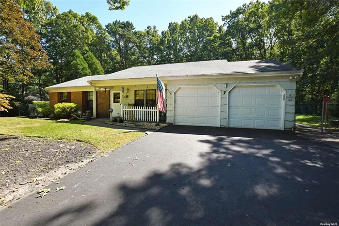 Enjoy the privacy sitting on the covered front porch of this gorgeous ranch home with many upgrades.  Features include beautiful laminate flooring throughout the living space, updated kitchen and one year old CAC. Cozy family room with sliders to the back deck with electric awning which overlooks the private wooded backyard.  The Master Bedroom has a master bath, 2 additional bedrooms, first floor washer dryer and extra large 2 car garage. Impeccably maintained landscaping with custom stonework, in ground sprinklers and fenced back yard.