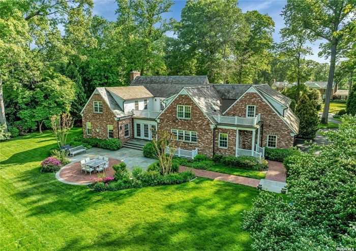 Fall in love with this classic brick residence from the moment you arrive. Built in 1938, this exceptional Colonial Cape has been thoughtfully reimagined and rebuilt by Cecilia Wheeler, offering the finest materials and attention to detail. Expanded to approximately 6, 800 square feet of comfortable, yet refined living space, each room is worthy of a grand celebration or a quiet evening relaxing. Upon entering, you will appreciate the intricate millwork and moldings, spacious formal living and dining rooms, paneled study and spectacular sun room, The home&rsquo;s centerpiece is its expansive gourmet kitchen designed by Bilotta in NYC, featuring Rutt Cabinetry, 2-inch Calcutta marble island and the finest appliances. Adjoining the kitchen is a sunny breakfast room and spacious family room with fireplace and custom bookcases, the perfect retreat for watching the big game or cozying up with your favorite book. A spacious mudroom, exquisite powder room and 3 car garage complete the first floor. All bathrooms feature marble tile, Waterworks fixtures and custom vanities. The finished lower level provides approximately 3, 000 square feet of functional space and oversized egress windows with home gym, family room, recreation room, custom laundry room, full bathroom and abundant storage. With 1 acre of flat, park-like private property, professionally landscaped by Ireland Gannon, you will enjoy outdoor gatherings and recreation with family and friends. A true Manhasset lifestyle, with an ideal central location to shops, train and schools. Munsey Park Elementary.