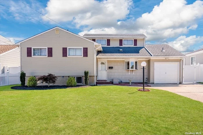 Welcome to this Split Level Home situated mid-block in the Village of Massapequa Park. The first floor is filled with abundant natural light, creating a warm and inviting atmosphere. Both the kitchen and living room feature charming bay windows, enhancing the brightness. The family room boasts sliding doors that lead to the backyard where a newly installed patio awaits for outdoor entertainment. The first floor has also been enhanced with premier new flooring. The second floor includes a thoughtfully designed layout, including a spacious main bedroom and a second bedroom, both newly carpeted for added comfort, A large family bathroom serves both rooms, offering plenty of space and even includes a vanity. The third floor includes bedroom three and four with extra closets and built in drawers connected by a jack and jill half bathroom perfect for shared use. The spacious backyard is perfect for outdoor enjoyment, entertaining, and relaxation. With plenty of room for various activities this backyard provides a great extension of the homes living space. The basement offers versatile space for ample storage and a laundry area for all of your organizational needs. Close to the convenient town shopping, restaurants and Massapequa Park LIRR station. Town of Oyster Bay amenities include beaches, parks and entertainment.