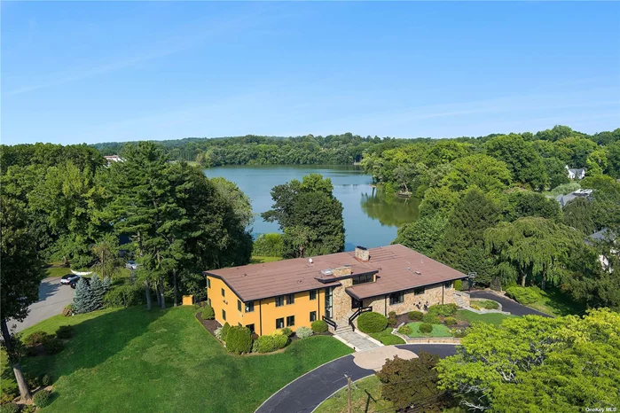 This extraordinary mid-century modern masterpiece spans over 10, 000 square feet of stunning architectural design. Featuring dramatic, large-scale rooms with soaring ceilings and expansive windows, this home seamlessly blends indoor and outdoor living, offering breathtaking panoramic views of pristine glacial Lake Success from nearly every vantage point. Every detail of this property reflects a refined elegance, with its sleek lines, open floor plan, and an abundance of natural light creating a luxurious yet comfortable living experience. Nestled on a private one-acre lot in the village of Lake Success, this home boasts an ideal combination of tranquility and convenience. Just 13 miles from Midtown Manhattan, offering a peaceful retreat while still being within easy reach of the city. The meticulously maintained grounds provide ample space for outdoor entertaining, with multiple decks and terraces complemented by the picturesque lake backdrop. The home features a grand entry foyer, dramatic living room with soaring ceiling, family room, and formal dinning room, plus 6 generously bedrooms, 6 1/2 baths, and a large above ground lower level great room that opens to the pool area. As part of the prestigious Lake Success community, residents have access to a private clubhouse, an 18-hole golf course, and pool club, enhancing the luxurious lifestyle this home affords. Whether you&rsquo;re hosting large gatherings in the dramatic living spaces or enjoying quiet mornings on the terrace overlooking the water, this property offers an unparalleled living experience, where modern luxury meets natural beauty.