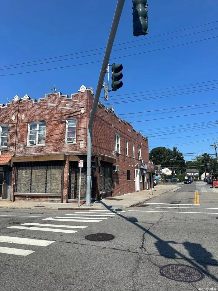 This Corner Brick Property is a Great Investment Opportunity for a business owner who could occupy the corner office / store with access to the full basement or ideal for an Investor who wants to rent everything. This mixed-use building offers 2 two bedroom apartments over 3 commercial office spaces / stores with 6 parking spaces in the rear of the building. A few blocks to the Cross Island Pkwy and minutes to all major Highways. Less than 2 miles to Belmont Park and UBS Arena. Close to restaurants, supermarkets, Starbucks, Dunkin Donuts, Banks etc... Convenient public transportation, with Bus services on the corner, about 2.1 miles to Bellerose LIRR, and about 20 minutes bus ride to Jamaica-179 Street Subway Station. This Property borderlines Nassau County. No statement is made as to accuracy of any description. All measurements and square footage are approximate.