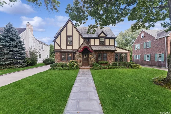 INSANE CURB APPEAL!! Discover timeless elegance in this beautifully maintained 3 BR, 2.5 bath English Tudor, perfectly situated on a 60 x 110 property in a prime Estates location. This lovely home blends classic architecture who modern updates, featuring a renovated 3 year old kitchen completed with custom cabinetry, quartz countertops, commercial grade appliances including a Wolf gas range, sub zero refrigerator and a farm sink. Wonderful space throughout, living room with wood burning fireplace, formal dining room, office, sunporch, sensational private yard with slate patio. Near to parks, schools and LIRR.