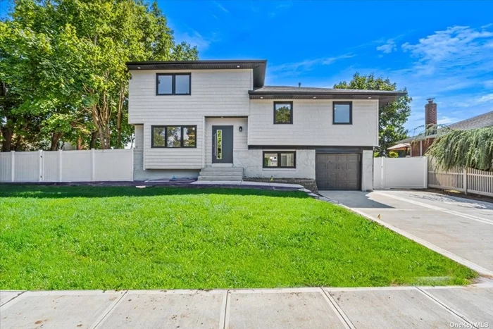 Welcome Home to this completely updated split-level expanded house features a modern and spacious design, with contemporary upgrades.  Upon entering, the main first level which boasts an open-concept living space with large windows allowing natural light to flood the room. The kitchen is fully renovated with high-end stainless steel appliances, quartz countertops, large eat in area , wine cooler and custom cabinetry with a side door leading to the backyard and the Pool The 2nd level level includes well-appointed 3 bedrooms, each with ample closet space, and a luxurious bathroom featuring a rain shower custom vanity all additional bedrooms are designed with updated fixtures. The 3rd level Boast of 2 large bedrooms and a custom designed bathroom, a small office or walk in closet. The lower level offers a finished family room with a full modern bathroom and walk out to your in ground pool. Sliding doors from the family room lead to the outdoor oasis surrounded by a beautifully landscaped yard perfect for summer lounging or barbecues. The pool area is complemented by privacy fencing, tasteful landscaping, and lighting for evening enjoyment.  The basement has a finished room that can serve as a recreation room or home office, The laundry with new washer dryer and Slop Sink is also at this level. This New Like Split Level home comes with New Sidings, Windows, Plumbing, Electric, Floors, Roof, HVAC, Kitchen , Bathrooms, Fence, Driveway, Appliances , New Garage Door with Remote and Inground Sprinkler System