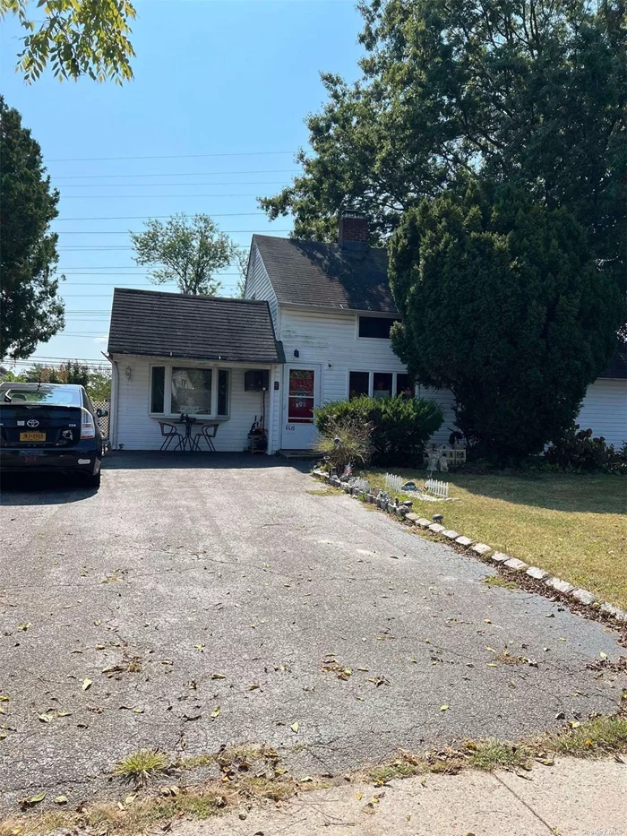 This expanded 4-bedroom, 2-bath ranch in Levittown offers 1, 470 square feet of comfortable living space with an open layout. The first floor features an eat-in kitchen with a dishwasher, a formal dining room, an extended living room, a master bedroom, an additional bedroom, a cozy den, and a full bathroom. The second floor includes a separate kitchen/living room area, a bedroom, and a full bathroom, perfect for extended family or guests. Additional features include a relocated boiler, a mother-daughter setup with proper permits, an oversized lot, an above-ground oil tank, pull-down attic storage, and a private driveway. Please note this is an unapproved short sale.