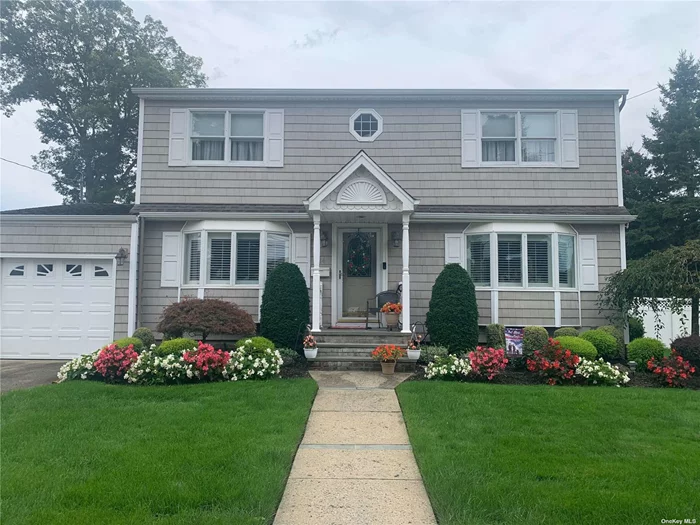 Welcome to your dream home - A well maintained three-bedroom, two bathroom colonial on an oversized 90x100 corner lot in a highly desirable Massapequa Neighborhood. Features: First floor has a eat-in kitchen, with granite countertops, and plenty of cabinet space with sliding doors to a Deck for entertaining your guests. Including a spacious living-room and a formal dining room. Upstairs has 3 bedrooms, plus a Primary bedroom with walk in closet and en-suite bath. Lower level has a full finished basement for family entertainment, utility room and lots of storage. This beautiful property has been meticulously landscaped with a nice size shed for storage, also includes a one car garage. Access to schools, shopping, dining, parks, and transportation. Convenience is at your fingertips. Minutes to LIRR, Jones Beach, parks, marinas and bike paths. Centrally located to all. This Colonial offers the perfect blend of comfort, and space. Make this your dream home!