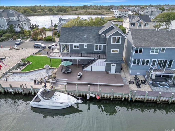 Welcome to your new sanctuary on the Great South Bay in Lindenhurst-a stunning 2-bedroom, 3-bathroom boater&rsquo;s paradise. You will enjoy breathtaking panoramic views and luxurious living harmoniously blended across three levels of elegant space. Experience unobstructed sweeping views of the Great South Bay from every angle of this exquisite home. With 80 feet of Navy wall bulkhead, this home is a boaters paradise. You will enjoy a front-row seat to stunning sunrises and serene sunsets every day. This expansive home features three thoughtfully designed levels, each offering unique spaces for relaxation and entertainment. The main level is designed to capture and enhance the natural beauty of its surroundings. Large windows flood the space with light, creating a bright and airy atmosphere perfect for both everyday living and entertaining. Both the main and lower level have radiant heating in the floors. The large primary suite boasts a huge ensuite with double vanity, extra wide 4ft shower with dual shower heads, body sprayers and jetted Jacuzzi Tub featuring water views. As you enter the kitchen you are greeted with granite counter tops and Stainless steel appliances, ample counter space, and custom cabinetry. Whether you&rsquo;re preparing a casual meal or hosting a dinner party, this kitchen has everything you need. The living area seamlessly connects to the wraparound waterfront deck with brand new Trex Deck. It is perfect for enjoying morning coffee, evening cocktails, or simply soaking in the tranquil surroundings. The expansive outdoor space is ideal for summer gatherings or peaceful solitude. The upper level boasts a family room, storage room and two bonus rooms that can become bedrooms with proper permits. The lower level is perfect for hosting guests or creating your own entertainment zone. With plenty of space for a game room, media area, or additional guest quarters, this level adds flexibility and functionality to your living experience. The summer kitchen provides ease and convenience while prepping for BBQ&rsquo;s and is perfect for entertaining guests. All three bathrooms are beautifully designed, featuring contemporary fixtures, stylish tile work, and ample space for pampering. There are 2 driveways and plenty of street parking for guests. Situated in the charming community of Lindenhurst, you&rsquo;ll benefit from a serene environment while being conveniently close to local amenities, schools, and transportation options. This remarkable home offers an unparalleled living experience on the Great South Bay, combining luxurious interiors with stunning natural beauty and versatile living spaces. Don&rsquo;t miss the opportunity to make this waterfront dream home yours. Schedule a showing today and envision the life you could lead in this extraordinary setting!