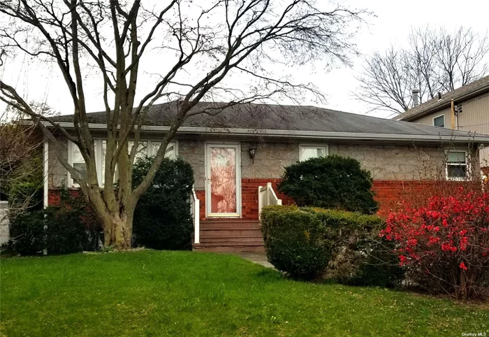 Bayside Raised Ranch, 3 Bedrooms, EIK, LR, DR, Hardwood Floors through out. Cozy Porch that leads to BackYard. 1 1/2 baths. Full Partially Finished Basement with Laundry Room and Exit to 2 Car Garage. property is 52 X 100 A must see.