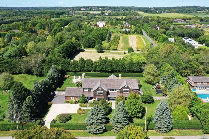 Situated on a quiet cul de sac in Bridgehampton, this traditional is the quintessential Hamptons home, combining elegant design with a modern flair. The first floor of this 8, 200 +/- sq ft residence is entered through a beautiful foyer leading to a great room with cathedral ceilings, floor-to-ceiling windows, French doors, and a fireplace with built-in mantle. Fully equipped with top grade, stainless steel appliances, the gourmet kitchen has a walk-in pantry, marble center island and a breakfast area, all of which open to a comfortable family room with fireplace. Built for convenience, the butler&rsquo;s pantry with beverage center, opens to the formal dining room. The beautiful oak library features custom book shelving and paneled ceilings. Also on the first floor, the junior master bedroom has a large walk-in closet, full bathroom, and French doors to the bluestone terrace. Upstairs, four generously sized guest bedrooms each offer large private baths and walk-in closets. The master suite has a fireplace, large walk-in closet, sparkling bathroom with free standing soaking tub and double sink vanity as well as, expansive mahogany terrace overlooking the grounds and reserve. A laundry room is also found on the second level. Fully finished, the lower level comprises a recreational room with built-in bar and a fireplace, a media room, gym, wine cellar, and a bedroom with full bathroom. This magnificent offering is completed with a heated gunite pool encompassed by bluestone terracing, as well as a radiant heated two-car garage. The 1.00 +/- acre grounds are adjacent to a reserve and are professionally landscaped.