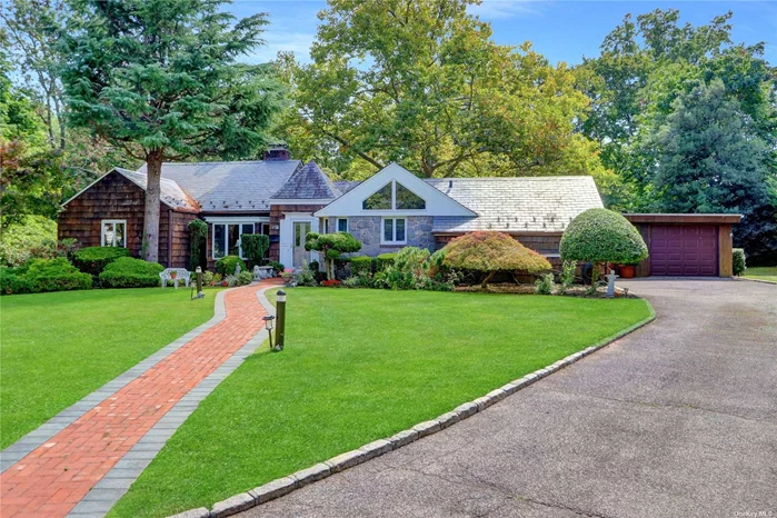 This sprawling ranch sits on an oversized property, offering endless possibilities! Boasting 2, 200 sq ft of living space, the home welcomes you with a grand entry hall leading to a formal living room with a gas fireplace and a formal dining room. The bright garden room, also with a fireplace, adds a cozy touch. The eat-in kitchen features beautiful windows, while the spacious family room and half bath provide comfort and convenience. The master suite is complemented by two additional bedrooms and a full hall bath. The full finished basement offers extra living space, and gas heating ensures efficiency. Outside, enjoy the expansive backyard with a deck and paver patio, perfect for entertaining! This home sits in both Roslyn & East Williston School district.