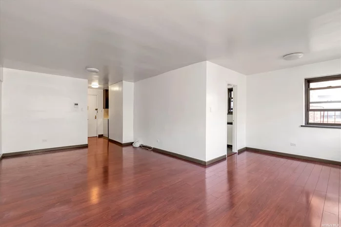 Welcome to this huge alcove studio in an Elmhurst co-op elevator building. This sunny corner apartment is located on a high floor with 2 exposures, and has been customized with mahogany colored hardwood floors throughout. The kitchen has been renovated with a tiled floor, plenty of cabinetry and quartz countertops. The bathroom is beautifully updated with a custom glass sliding door, modern tiles, a rainforest shower as well as a handheld shower head, and a new contemporary sink. Low maintenance of $ 438/month. This Ideal location allows for an easy commute to the city and the airport with the E, F, M and R subway on Woodhaven Blvd. Additionally, Queens Center Mall with its abundance of shopping and world-class restaurants is just one block away! Cats and subletting permitted.