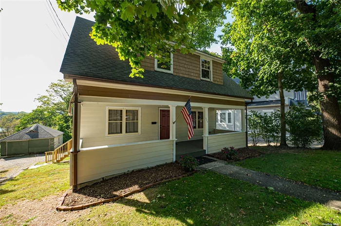 Recently renovated historic house with marina water views on iconic Woodbine Avenue in Northport Village.Main floor is living room, updated kitchen w/granite counter tops, breakfast nook.  This two story home boasts large front porch and two enclosed summer porches on second floor in addition to two bedrooms. Separate exit from basement is partially finished and is ideal for office space.Accss to lagoon for kyacking and canoeing. Close to parks, village dock, Main Street restaurants, theater and retail shops.