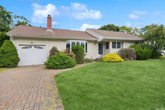 Charming ranch in Hampton Bays, this home offers a perfect blend of tranquility and convenience. Enjoy the close proximity to parks, schools, and local shops, just a short 3 miles to Ponquogue Beach. This spacious expanded ranch has a large primary ensuite and two guest bedrooms, full updated hall bath, hardwood floors throughout, living room, fireplace dining area, den overlooking deck and backyard, generous size kitchen with room for an island, plenty of cabinetry, deck, fenced in yard. Central A/C and garage, what else do you need?