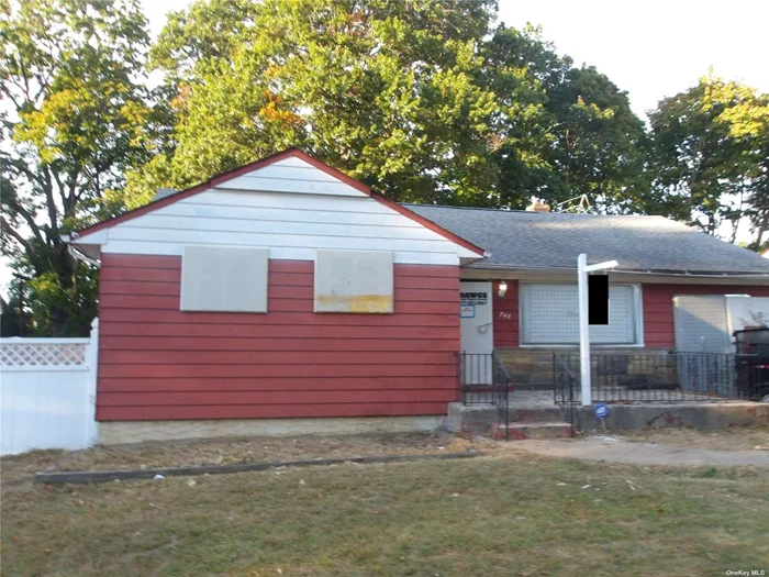 Charming single-family home on an approximately 6, 100 sq. ft. lot. This residence features 3 bedrooms, 1.5 baths (one full, one half), and a one-car garage. Enjoy a spacious backyard perfect for outdoor activities. Conveniently located near the Long Island Railroad for easy commuting.