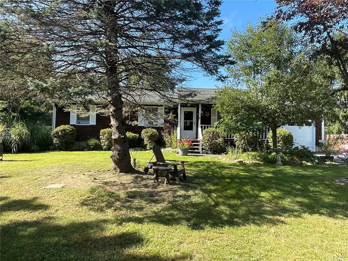 This cedar shake ranch home is located in the quaint village of Jamesport on a quiet cul-de-sac in the heart of wine country. Privacy abounds with mature trees surrounding this home that sits on a shy acre. Southern exposure and 3 skylights bathe the home in sunlight. The home features a living room with cathedral ceilings and large picture window, a formal dining area, EIK with plenty of storage, primary bedroom with full bath, 2 guest bedrooms and full guest bath. Full basement with inside entrance for extra storage and utilities, attached one car garage, expanded driveway, front porch and back deck. Possibilities abound with the large private yard for your choice of activities. There is also a shed to store all your gardening supplies. Close to beaches, wineries, farm stands, Riverhead shopping, Tanger outlets and many restaurants.