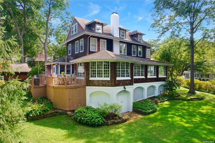 Discover the charm and elegance of this beautifully restored Victorian home, originally built in the late 1800s. With three levels of refined living space, this home masterfully blends historic character with modern comforts. The first floor features a large living room with architectural beams and a fireplace, a spacious dining room with its own fireplace, and a generous kitchen with a back stair leading to the second floor. Both the living and dining rooms open into a 44+ ft enclosed porch/family room with an abundance of windows overlooking the beautiful property. The library, which also makes for a perfect home office, and two convenient half baths complete the first floor. Upstairs, the second and third floors offer four generously sized bedrooms, including a primary suite with its own fireplace and full bath. Two additional full bathrooms ensure comfort for family and guests alike. Additional features include a full basement, a large outdoor deck ideal for gatherings, and a two-car garage. Located within the prestigious Port Washington Schools district, this home also includes access to beach and mooring rights with a nominal membership fee.