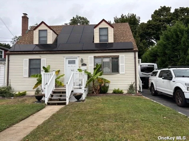 Beautiful and Cozy Copiague Expanded Cape Legal 2 By permit 1 1/2 garage. (Check with local Zoning). SS appliances Vinyl siding, Solar panels (purchased) Gas Heating, Hot water Heater,  Detached Shed. Fully finished basement wit outside entrance. Family room, office. Huge fenced yard, Covered Patio for entertainment, Pond, Sprinkler system-5 Zones