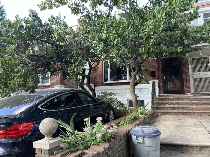 Semi-attached 2-family brick house with garage, on a quiet tree-lined street just one block from Bay Parkway train station. In the heart of Bensonhurst, everything is just moments from your doorstep- supermarkets, restaurants, retail stores, parks, schools, N/F trains and bus stations. This sun-filled, south facing home has wonderful architectural details including bay windows, ornate ceilings, tiled floors, as well as hardwood trim and floors throughout the house. A peach tree in front of the house produces lovely fruit during the Spring time. On the first floor, there is a living room, bonus office area, kitchen, dining room, and bedroom. Upstairs you&rsquo;ll find a bright airy unit w/ skylight, 2 bedrooms, living room & eat in kitchen. Rent one unit out and have your tenants help pay your mortgage! Downstairs you&rsquo;ll find a finished basement perfect for guests. One car garage plus one off street parking in front of the house complete this wonderful home.