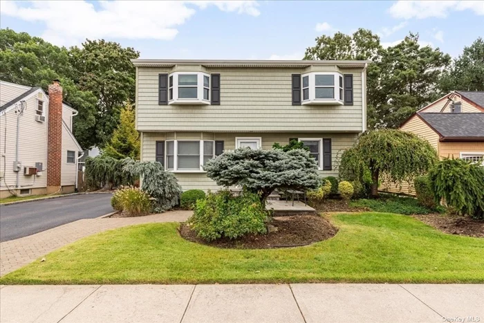 Welcome to 144 North Queens Avenue, Massapequa! This versatile 1, 762 sq. ft. Colonial-style home can be configured with up to five or six bedrooms and two bathrooms. There was a mother and daughter permit in place years ago, so that can be another option. Highlights include an extended eat in kitchen with island and Corian counter tops. Over sized detached garage with lots of storage. A long driveway that can accommodate three cars. A finished basement that you can have a den or office space in. Refinished hardwood flooring, newer windows, updated hot water heater, central air conditioning and potential for two kitchens. Enjoy oil heat with gas available on the block. Impressive landscaped 5, 500 sq. ft. lot features a newer patio with retractable awning and sprinklers. The roof and siding are just 10 years old. Endless possibilities await!