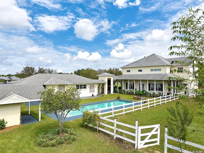 Experience country living in this custom built, European style two story home on an extensive five acre lot. Located in the prestigious gated equestrian community of Ranch Club in Groveland. A serene oasis 40 minutes from Orlando and away from the hustle and bustle of the city.  Magnificent four on-suite bedrooms and a half bath in the main house and a guest/ in-law suite attached to the main house with a breezeway. With over 4097 premium square feet in the main house plus 414 square foot guest/ in-law suite. Modern open air salt water pool, wrap around porch, and four stall pristine horse barn large enough to fit an RV with included tack room. The bright chefs kitchen features shaker cabinetry, pull out pantry, stainless steel counter tops and a prep island complete with butcher block top. Stainless steel high end appliances and a new European six burner commercial quality gas range. Spacious dining room with built in cabinetry and glass display cabinets with an abundance of natural light. Two on-suite bedrooms located downstairs. Dry bar and storage area. Spacious lounge with gas fireplace with marble surround. Upstairs there is a large open plan social/media area leading onto the master suite and additional adjoining bedroom upstairs, perfect as a nursery. The vast master bathroom includes dual sink vanity, stainless steel tops, tub and walk through shower with dual rain heads for a luxurious shower experience. Custom built walk in closet complete with private laundry tower. Master bedroom suite adjoins a generous office/ study. Guest suite has an included bathroom with shower. Suite features a bright bedroom with sliding door facing the pool and a screen porch. Mini kitchen with sink, laundry, refrigerator and dishwasher. Mature gardens surround the property including many fruit trees and a fenced dog run or paddock.  This home has too much to list, must be seen to be appreciated. Move in ready.