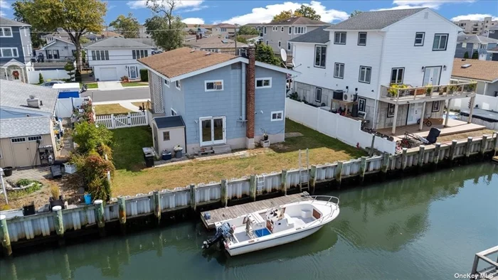 This amazing waterfront home is a boater&rsquo;s dream, just 6 minutes from the open bay, offering 4 bedrooms and 2 full baths. The gorgeous open layout features a welcoming living room and dining room with wood floors that flows into an upscale Eat-In Kitchen with tile floors, complete with an island for casual dining and entertaining. The main level includes 3 bedrooms and a beautiful full bath. The lower level is perfect for extended family or guests. Can be a Mother/Daughter with proper permits. This space includes a cozy living room with wood-burning stove & sliders that lead to the scenic waterfront backyard, a private bedroom, a full bath, additional room & a laundry room. Enjoy the perks of waterfront living with a 6-year-old vinyl bulkhead, ideal for docking your boat or simply taking in the stunning views. Host gatherings in your backyard while savoring breathtaking sunsets. Additional features include an attached 1-car garage, efficient gas heating and low taxes. Conveniently located near shopping, dining, the Nautical Mile & parkways. This home offers the perfect blend of luxury, convenience & waterfront charm!