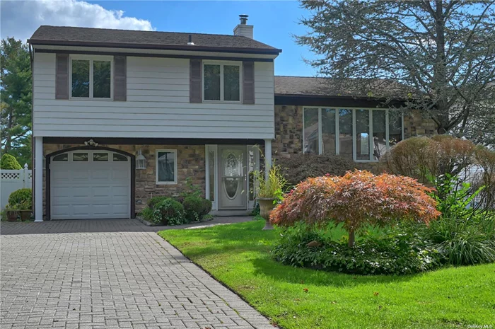 Welcome to this beautifully expanded 3-bedroom split-level home in the heart of Farmingville, NY. This unique property stands out with its impressive and spacious layout, offering much more than your typical split. The first level features gleaming large-tile radiant heated floors that open to a meeting or sitting area and continues to an even larger living room with a fireplace and glass French doors plus oversized windows that let in a tremendous amount of light and give a spectacular view of your in-ground pool. This level also features an easily accessible powder room. The second level boasts a large expansion, featuring a stunning, oversized catering kitchen and dining area with vaulted ceilings and skylights, creating a bright and airy atmosphere. Adjacent to the kitchen is a generous family room, perfect for gatherings, The Kitchen also has French doors leading to the oversized deck that overlooks the sparkling L-shaped in ground pool.  The upper level is dedicated to the sleeping quarters, featuring a spacious master bedroom, two additional bedrooms, and a full bath. This is one of the rare splits in the area with a basement which offers a partially finished space that includes a laundry area, utility room, and additional storage. This home is perfect for those seeking a combination of space, comfort, and convenience in a desirable Farmingville location. Don&rsquo;t miss the chance to make this exceptional property your new home!