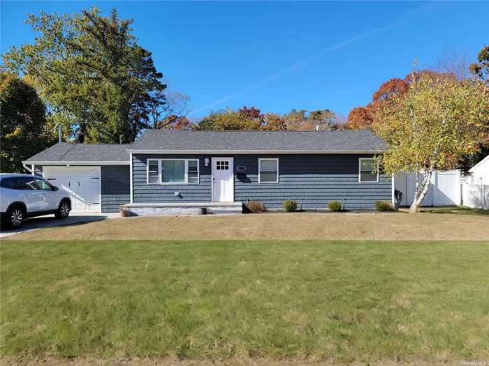 Beautifully Renovated 4 Bedroom, 2 Bathroom Home in Bay Shore, NY. This spacious and modern home offers an open-concept design with a stunning eat-in kitchen featuring stainless steel appliances, quartz countertops, and ample cabinetry. The living/dining area boasts cathedral ceilings and a cozy gas fireplace, perfect for entertaining. Gleaming hardwood floors flow throughout the home. Outside, enjoy a large yard with a deck, perfect for relaxing or hosting gatherings. Additional features include a garage, driveway parking, and a great location close to shops, restaurants, and more. Don&rsquo;t miss this gem!